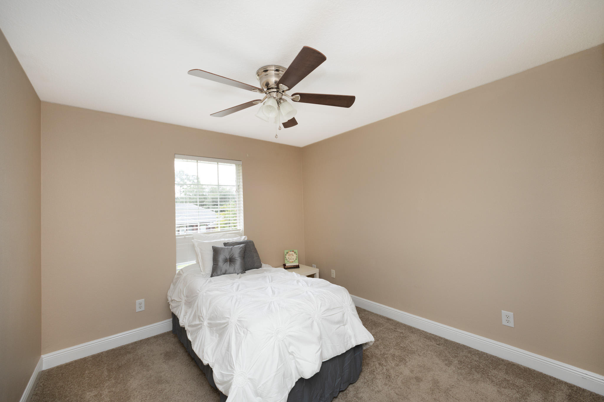 653 Territory Lane Crestview, FL 32536 - Photo 22 of 29 a bedroom with a bed and window