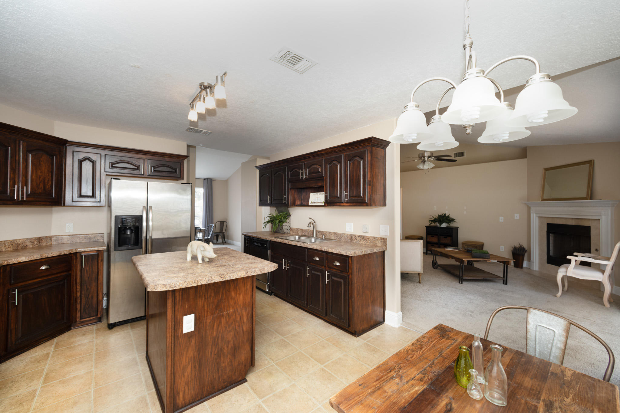 653 Territory Lane Crestview, FL 32536 - Photo 7 of 29 a large kitchen with a sink stainless steel appliances and chandelier