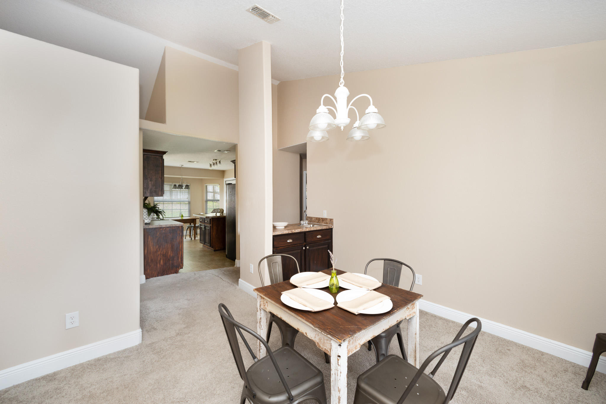 653 Territory Lane Crestview, FL 32536 - Photo 10 of 29 a view of a dining room with furniture a chandelier and wooden floor