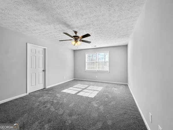 a view of a brick wall with staircase in front of it