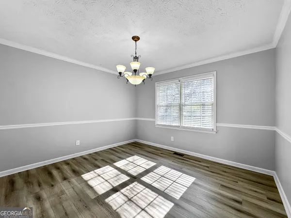 a view of wooden floor and windows in a room