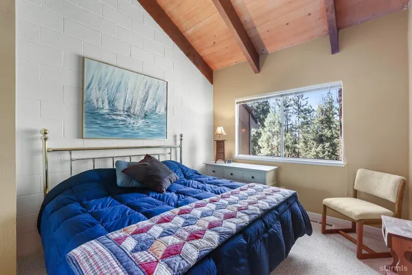 a bedroom with a bed window and couch