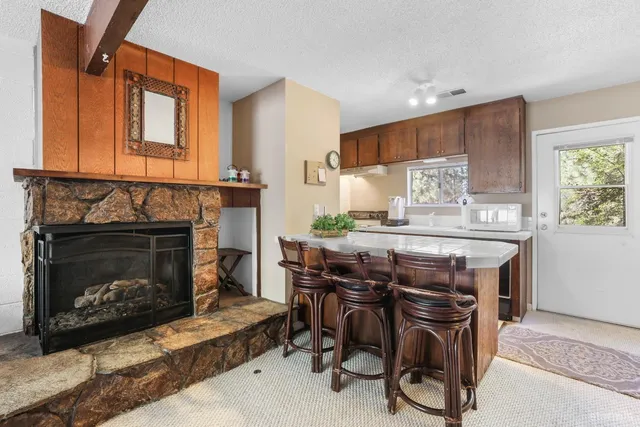 a kitchen with a table chairs and a fireplace