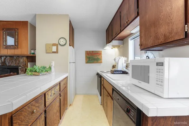 a kitchen with a stove and a white cabinets