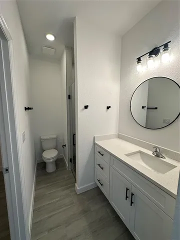 a bathroom with a sink a toilet and a mirror