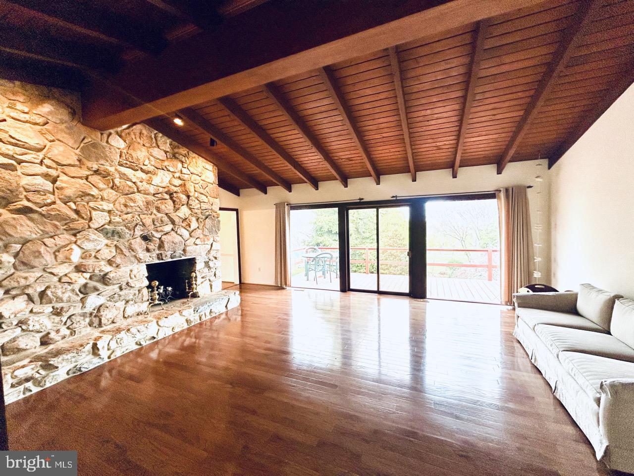 14820 Old York Road Phoenix, MD 21131 - Photo 6 of 22 a view of an empty room with a fireplace and wooden floor