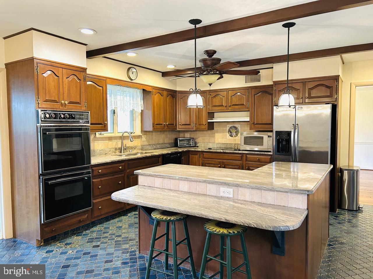 14820 Old York Road Phoenix, MD 21131 - Photo 8 of 22 a kitchen with stainless steel appliances wooden floor dining table and chairs