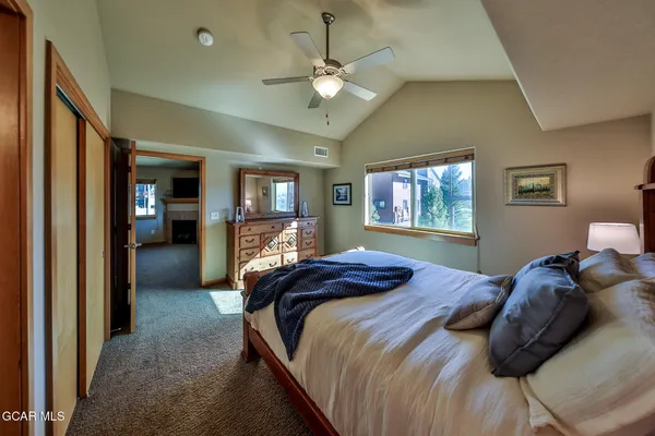 a bedroom with a large bed and a chandelier