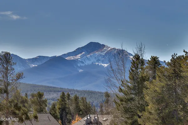 a view of a house with a mountain in the background