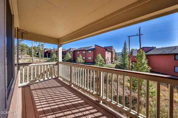 a view of a balcony with furniture