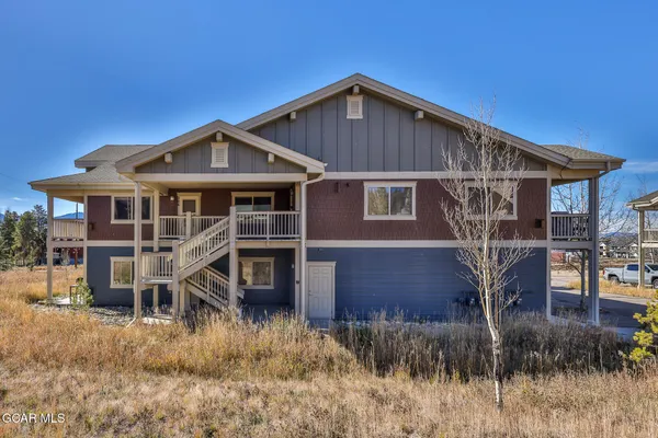 a view of a house with wooden fence
