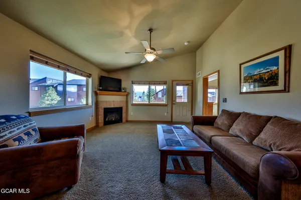 a living room with furniture a fireplace and a flat screen tv