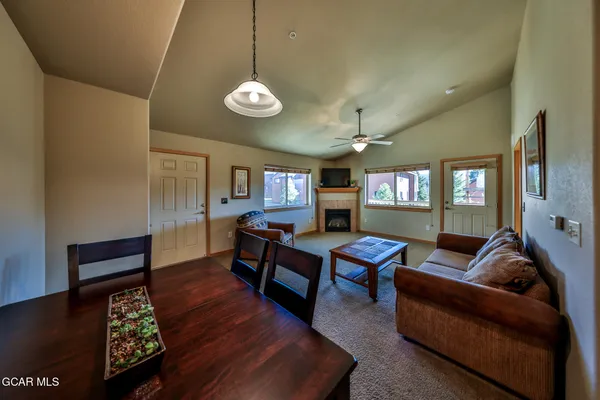 a living room with furniture a wooden floor and chandelier