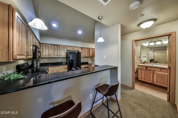 a kitchen with a sink cabinets and window