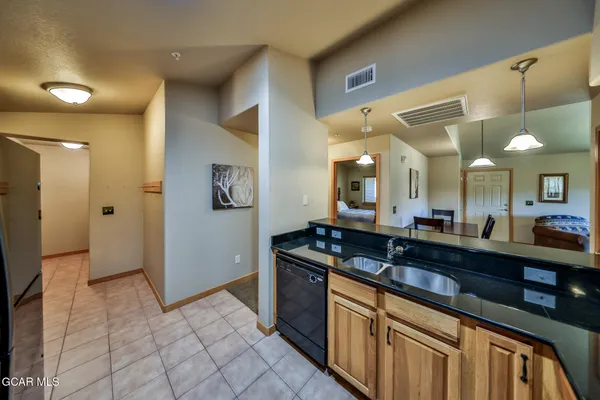 a kitchen with granite countertop a sink and cabinets