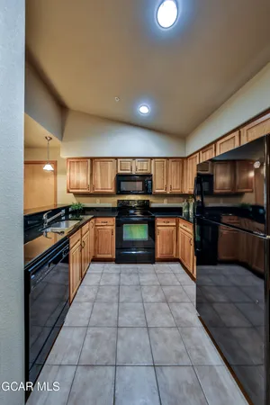 a large kitchen with stainless steel appliances and a kitchen counter top