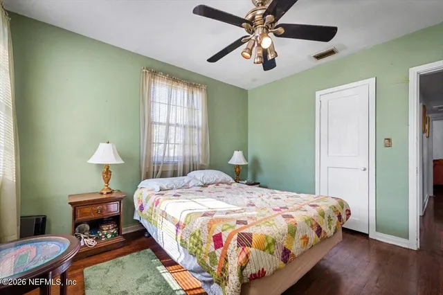 a bedroom with a bed a table and chair