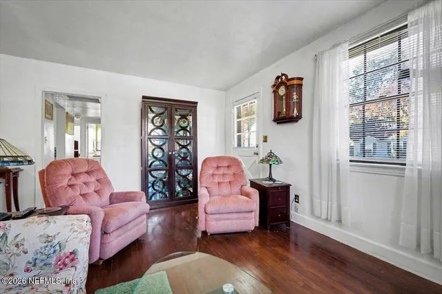 a living room with furniture and wooden floor