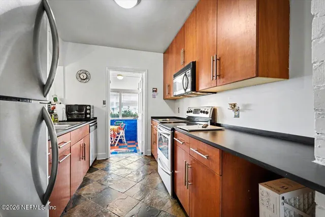 a kitchen with stainless steel appliances granite countertop a stove and a sink