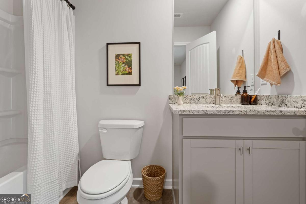 124 Meadowview Drive, Unit 12 Temple, GA 30179 - Photo 15 of 27 a bathroom with a toilet sink and mirror