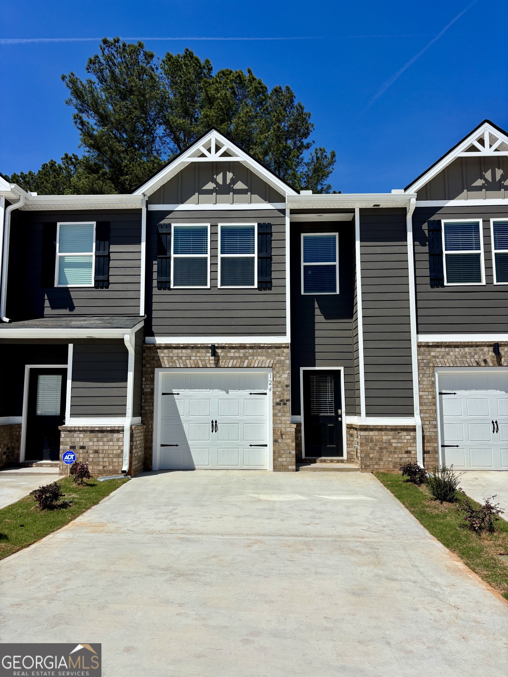 124 Meadowview Drive, Unit 12 Temple, GA 30179 - Photo 2 of 27 a front view of a house with a yard