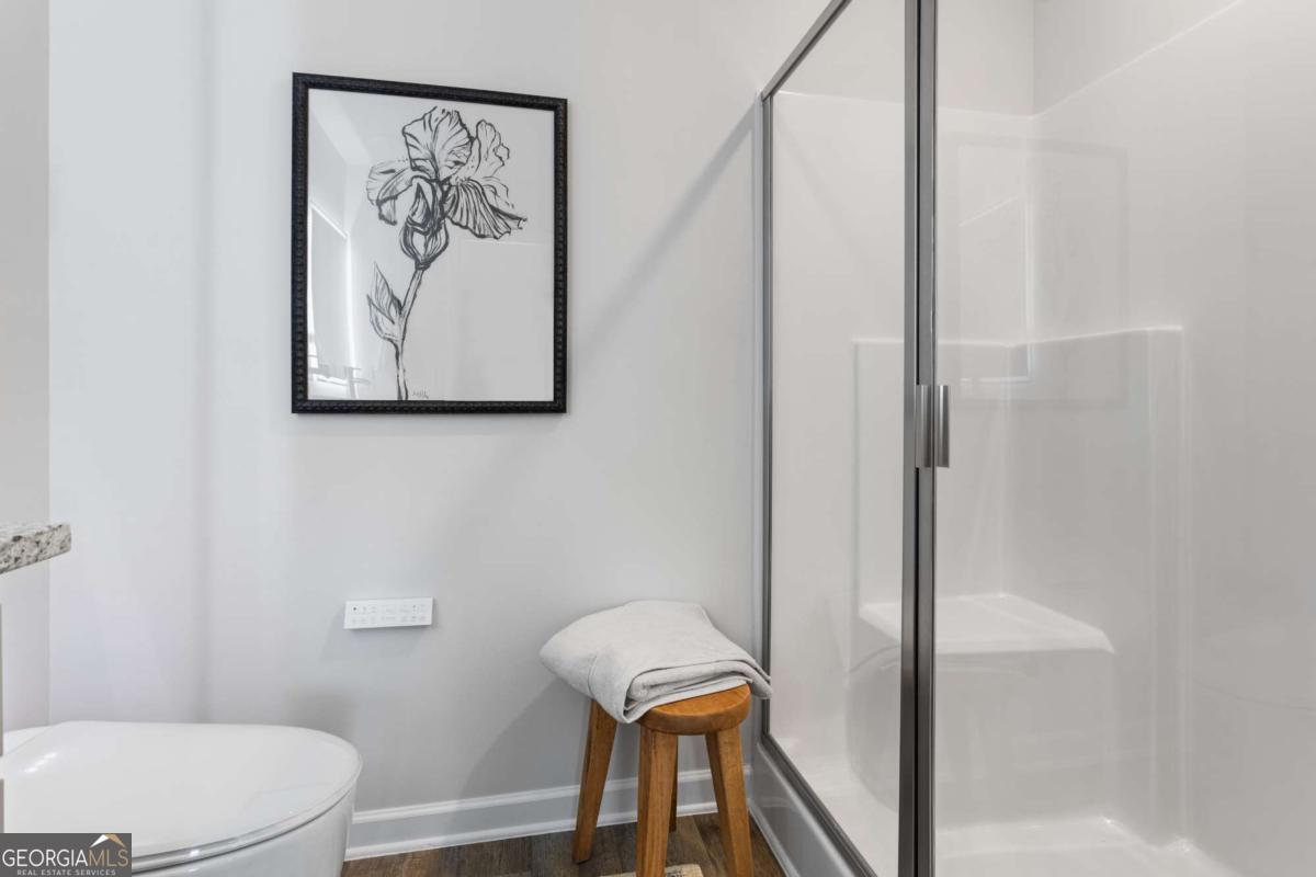 124 Meadowview Drive, Unit 12 Temple, GA 30179 - Photo 25 of 27 a bathroom with a toilet and a shower