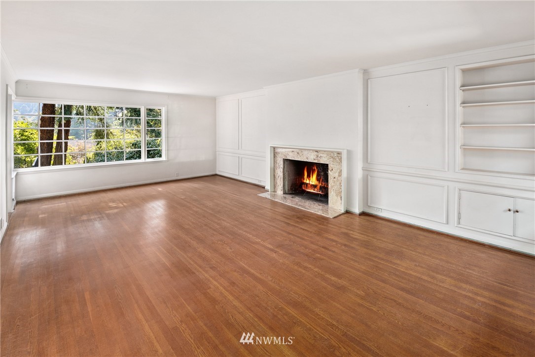 5527 Northeast Windermere Road Seattle, WA 98105 - Photo 4 of 34 wooden floor fireplace and windows in an empty room