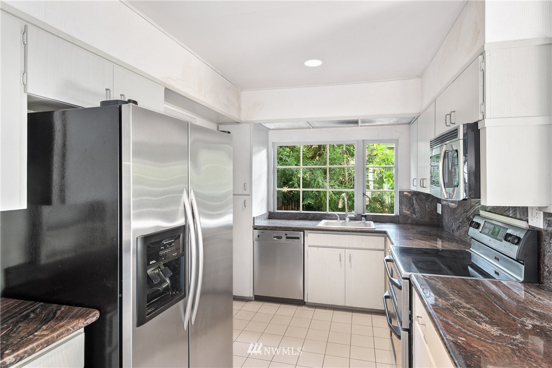 5527 Northeast Windermere Road Seattle, WA 98105 - Photo 7 of 34 a kitchen with a stove a refrigerator and a sink