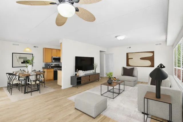 a living room with furniture wooden floor and a flat screen tv