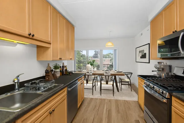 a kitchen with a sink stove top oven and cabinets