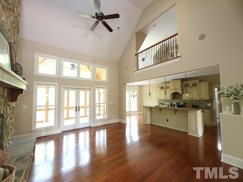 3460 Century Farm Road Wake Forest, NC 27587 - Photo 11 of 25 a hallway with a wooden floor and a kitchen view