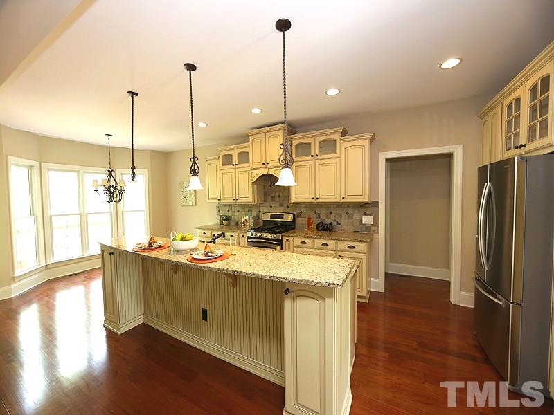 3460 Century Farm Road Wake Forest, NC 27587 - Photo 12 of 25 a kitchen with stainless steel appliances granite countertop a sink a stove and refrigerator