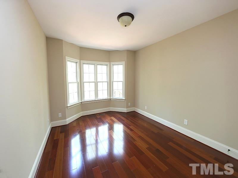 3460 Century Farm Road Wake Forest, NC 27587 - Photo 17 of 25 an empty room with wooden floor and windows