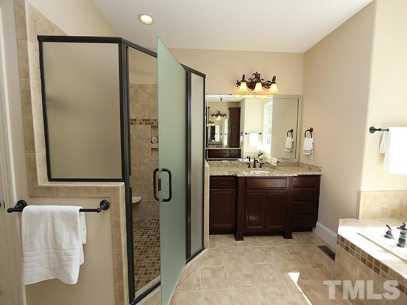 3460 Century Farm Road Wake Forest, NC 27587 - Photo 20 of 25 a bathroom with a granite countertop sink a mirror and a shower