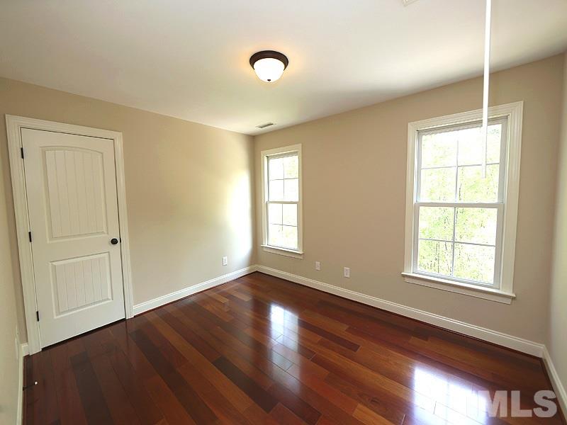 3460 Century Farm Road Wake Forest, NC 27587 - Photo 22 of 25 a view of an empty room with wooden floor and a window