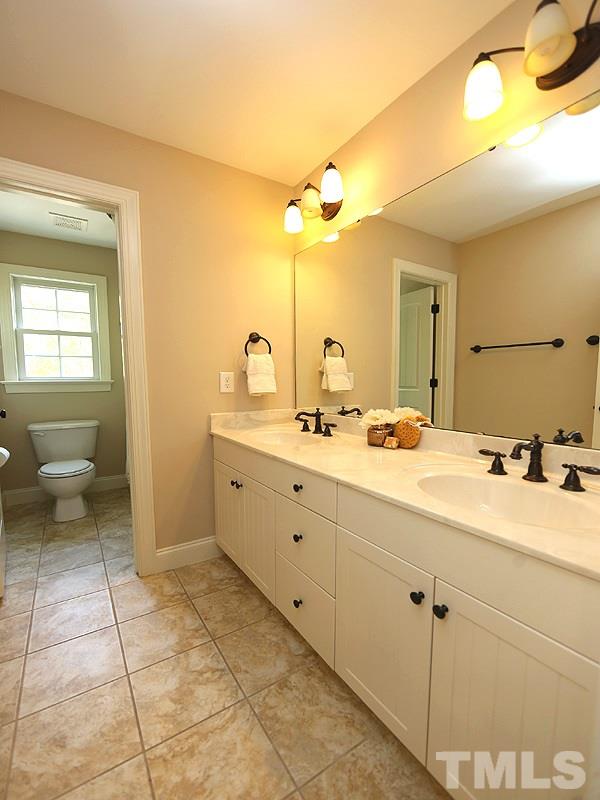 3460 Century Farm Road Wake Forest, NC 27587 - Photo 23 of 25 a bathroom with a double vanity sink toilet and a mirror