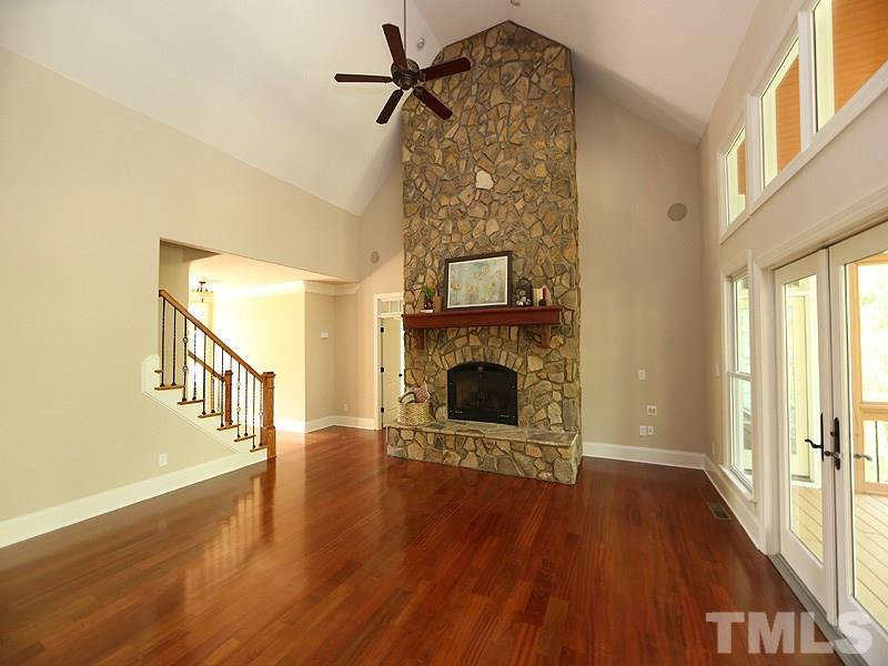 3460 Century Farm Road Wake Forest, NC 27587 - Photo 9 of 25 a view of a livingroom with wooden floor a fireplace and windows