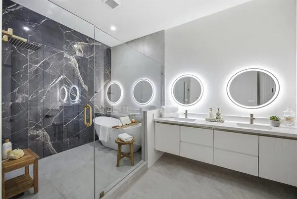 a bathroom with double vanity sinks and a mirror