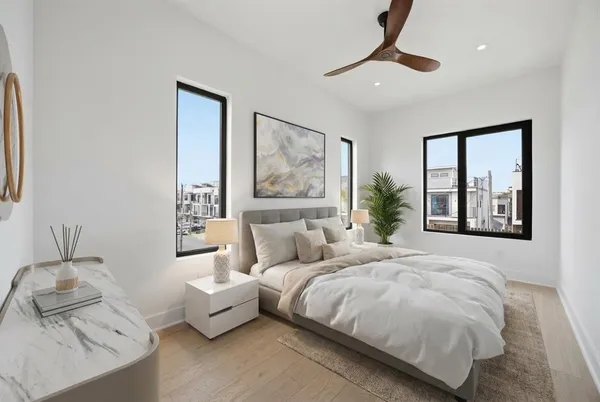 a bedroom with a bed and a chandelier