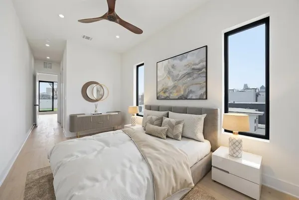 a bedroom with a bed and a painting on the wall