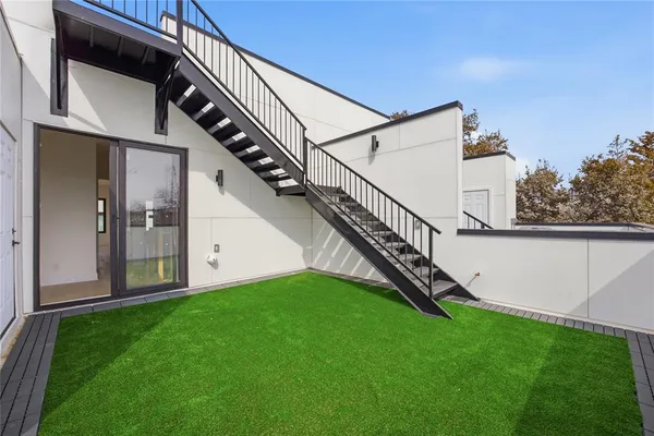 a view of an house with a yard and stairs