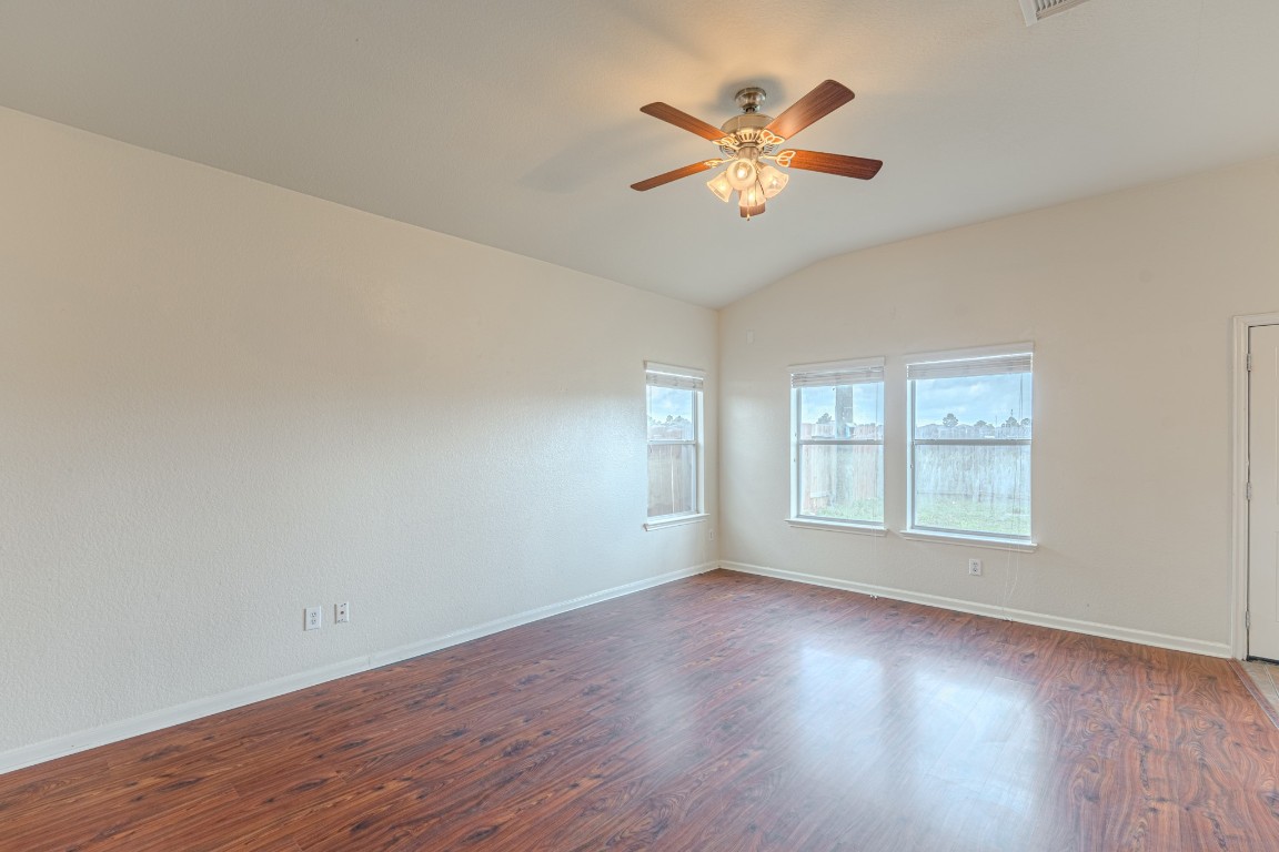6526 Bella Noche Drive Spring, TX 77379 - Photo 14 of 46 a view of an empty room with wooden floor and a window