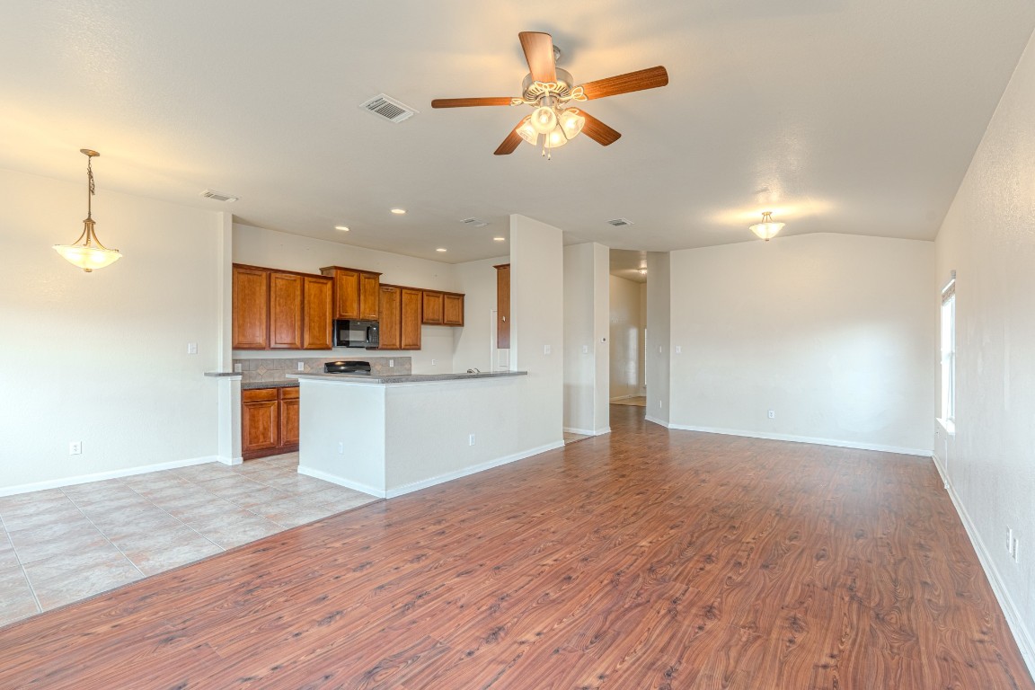 6526 Bella Noche Drive Spring, TX 77379 - Photo 16 of 46 a view of kitchen with kitchen island stainless steel appliances refrigerator stove and wooden floor