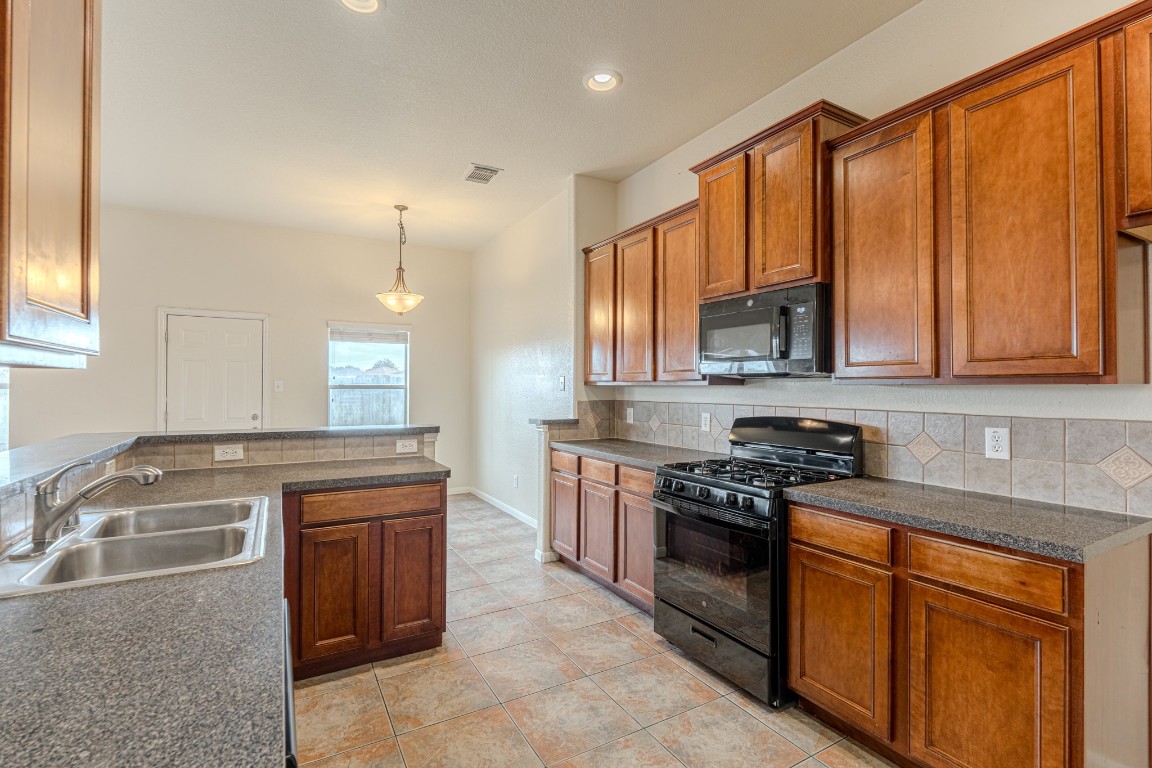6526 Bella Noche Drive Spring, TX 77379 - Photo 17 of 46 a kitchen with stainless steel appliances granite countertop a stove a sink dishwasher and a refrigerator