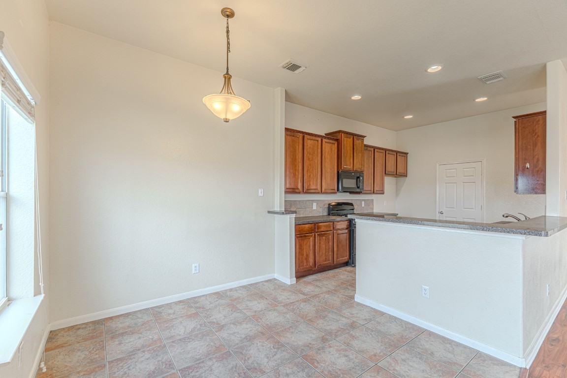6526 Bella Noche Drive Spring, TX 77379 - Photo 25 of 46 a view of a kitchen with granite countertop cabinets a sink a stove and a window