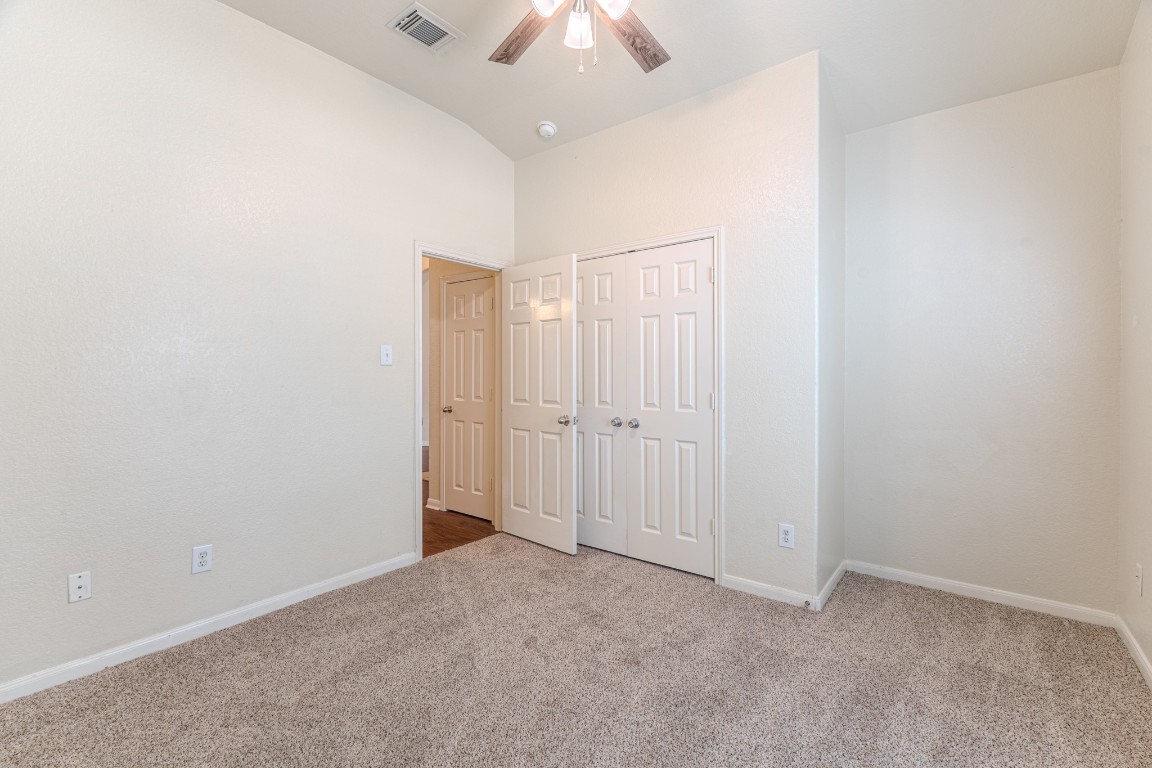 6526 Bella Noche Drive Spring, TX 77379 - Photo 40 of 46 an empty room with a chandelier fan