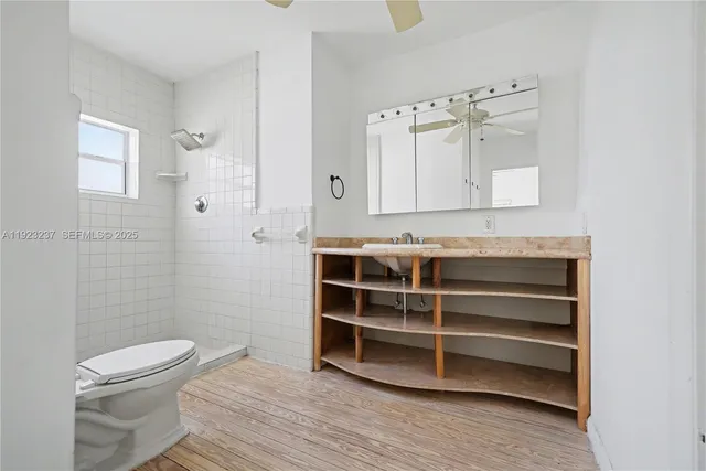 a bathroom with a toilet a sink and shower