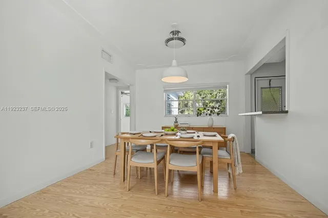 a view of a dining room with furniture window and wooden floor