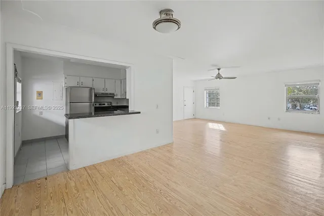 a view of a kitchen with microwave and cabinets