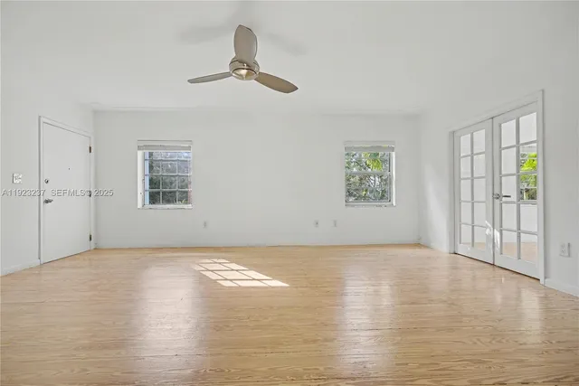 wooden floor in an empty room with a window